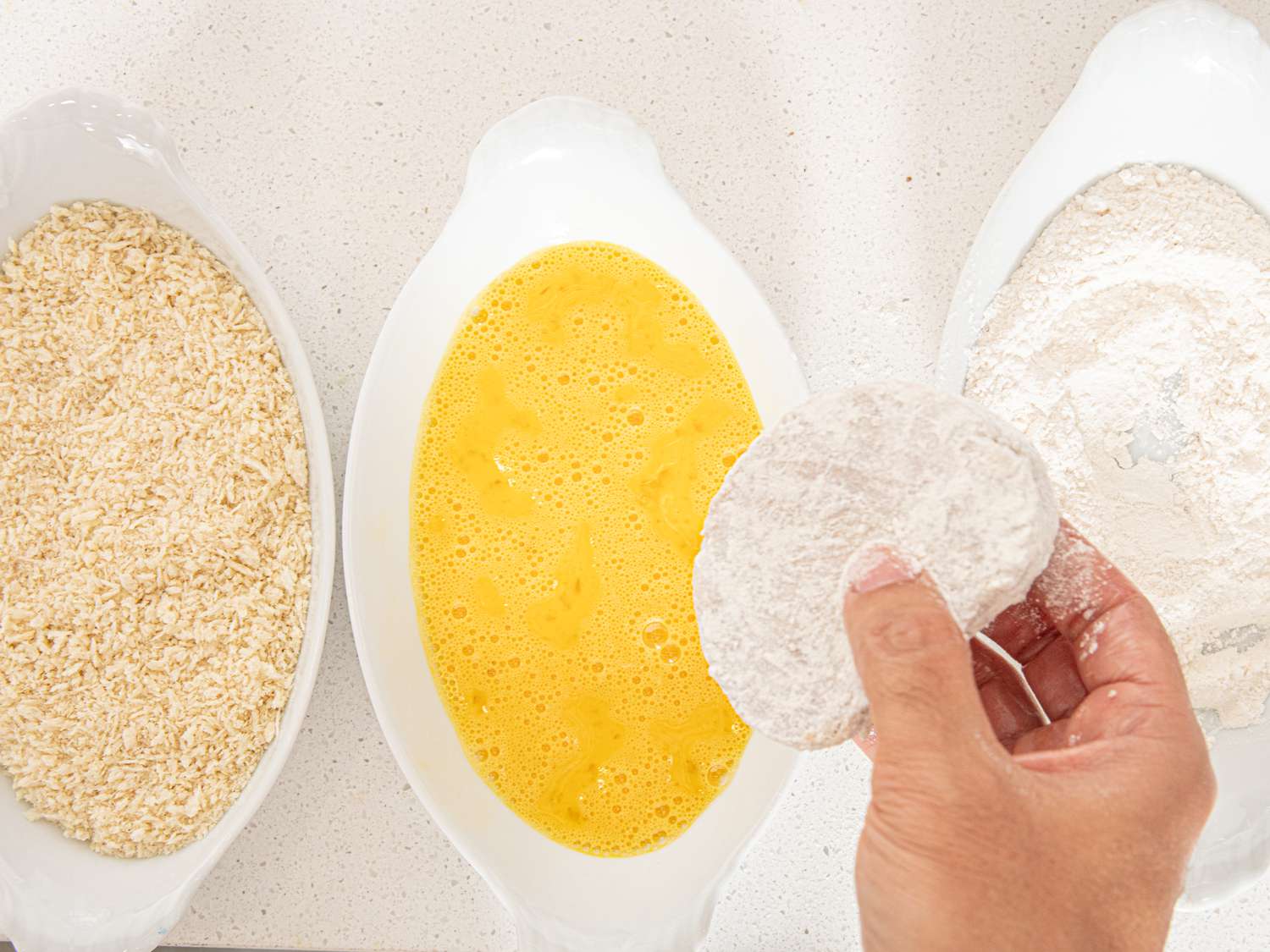 Overhead view of dredging pork croquettes