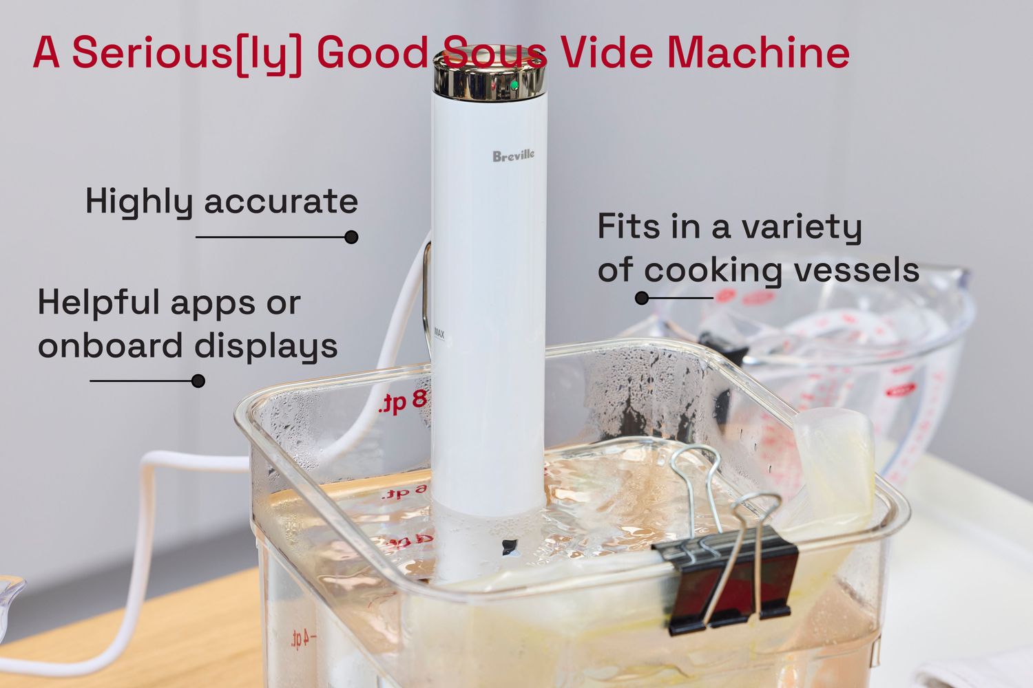 The Breville Joule Turbo sous vide machine in a plastic tub of water