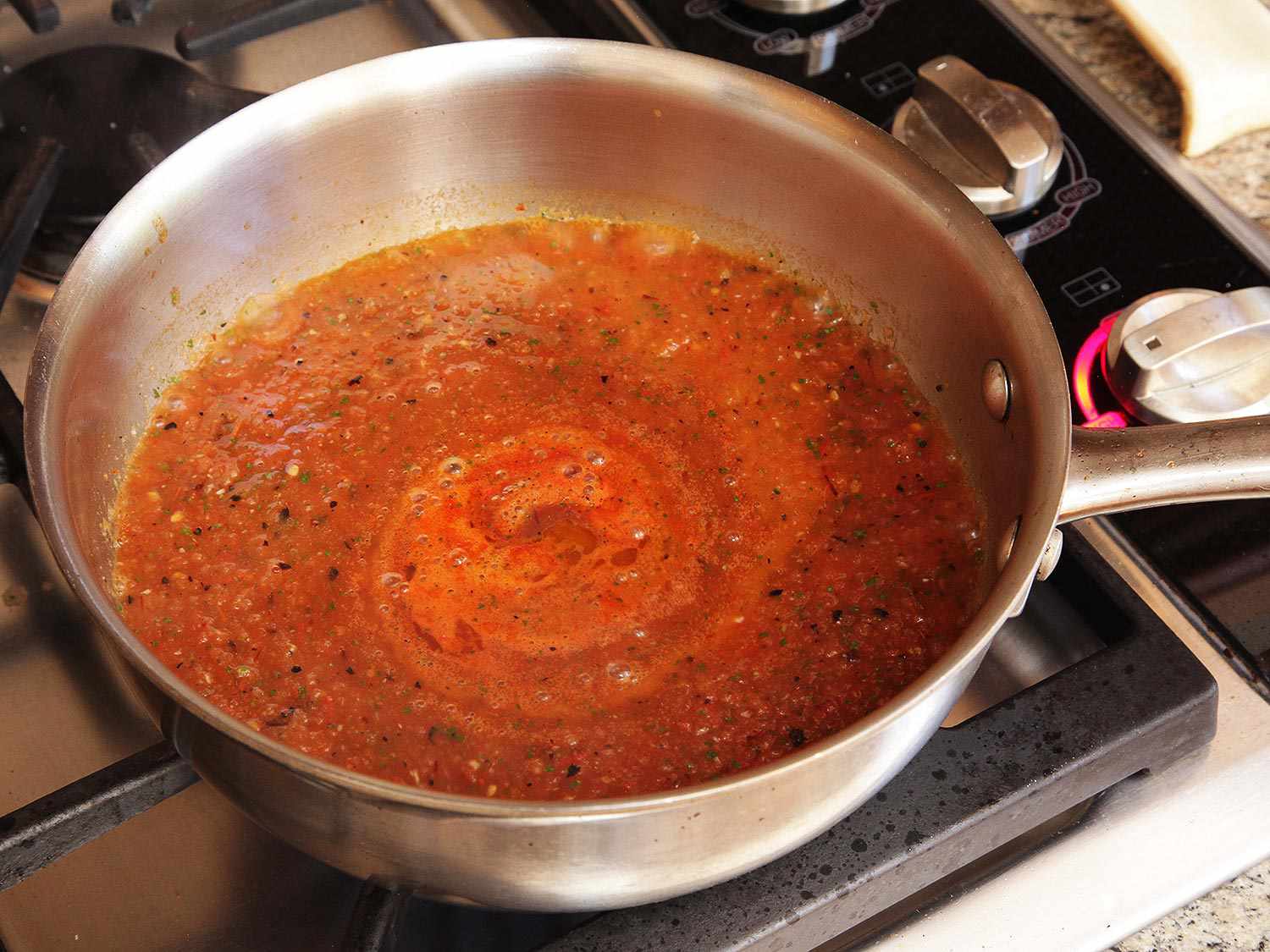 Cooking down salsa for chiles rellenos.