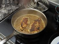 seared chicken in sauce in a saute pan