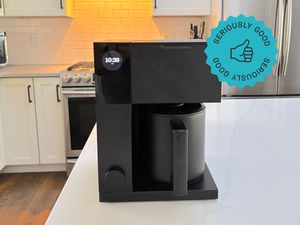 The Fellow Aiden coffee maker on a kitchen countertop.