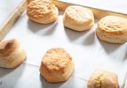 Six baked biscuits arranged on a parchmentlined baking sheet labeled with numbers