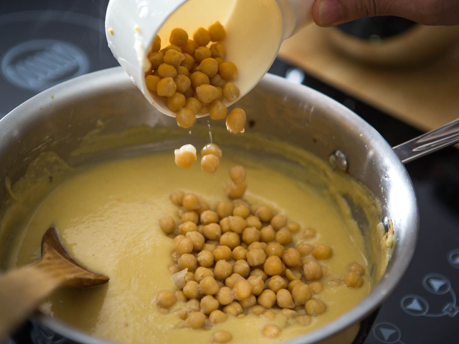 Whole chickpeas are added to the puréed chickpea sauce.