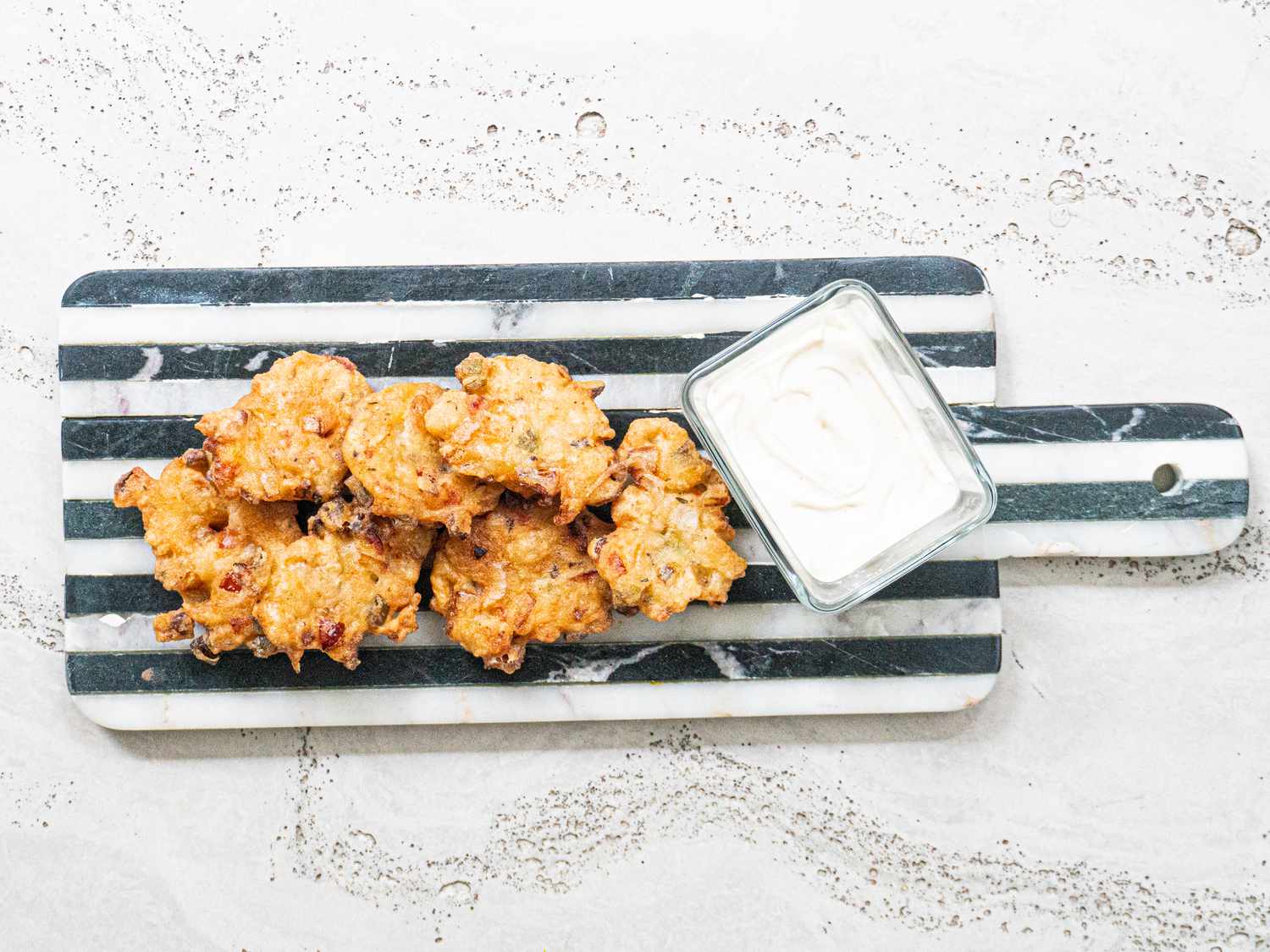 Fritters served with dipping sauce.