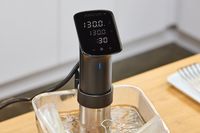 Anova Culinary Precision Cooker Pro on a container with water