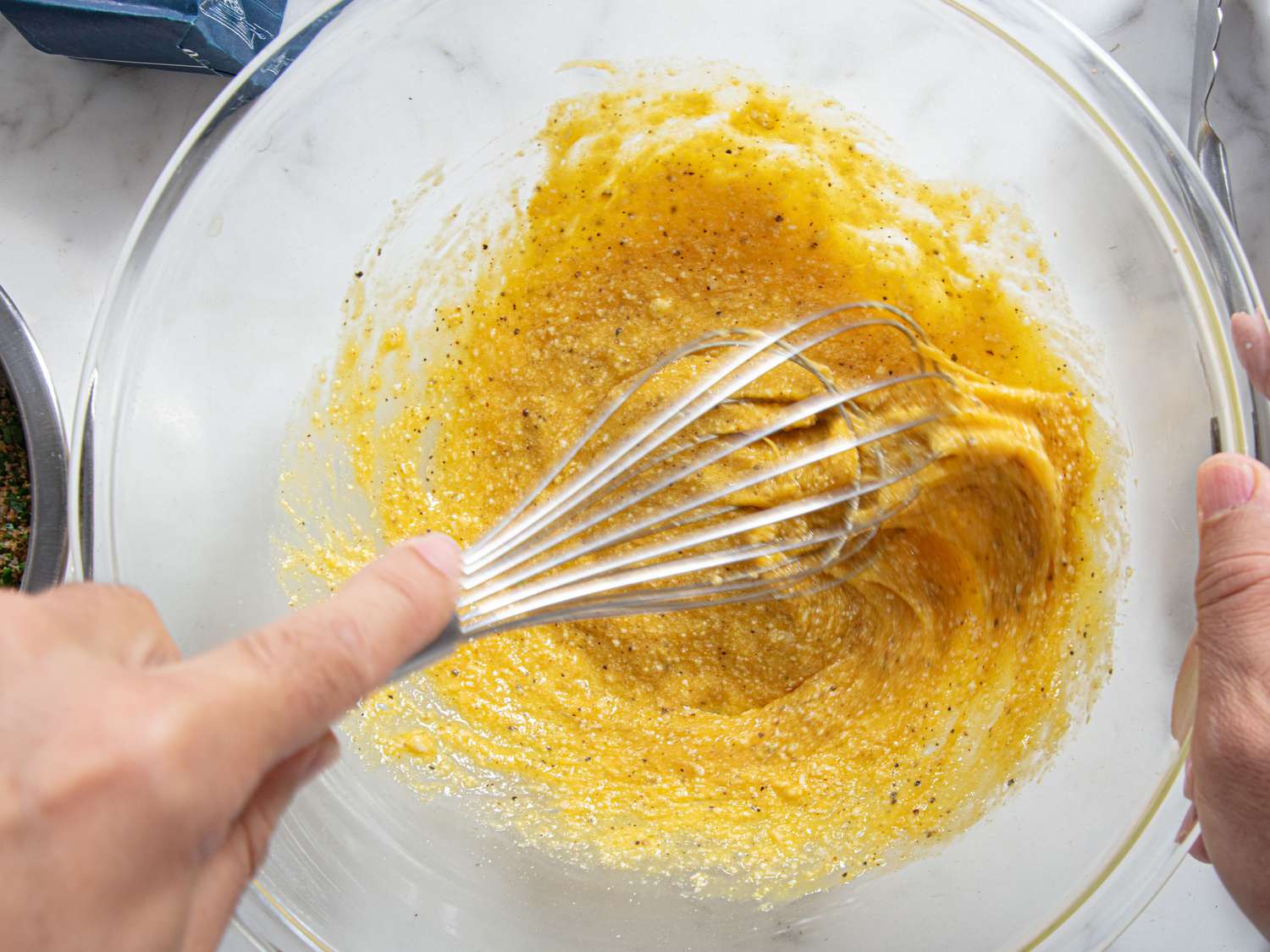 Overhead view of whisking egg sauce