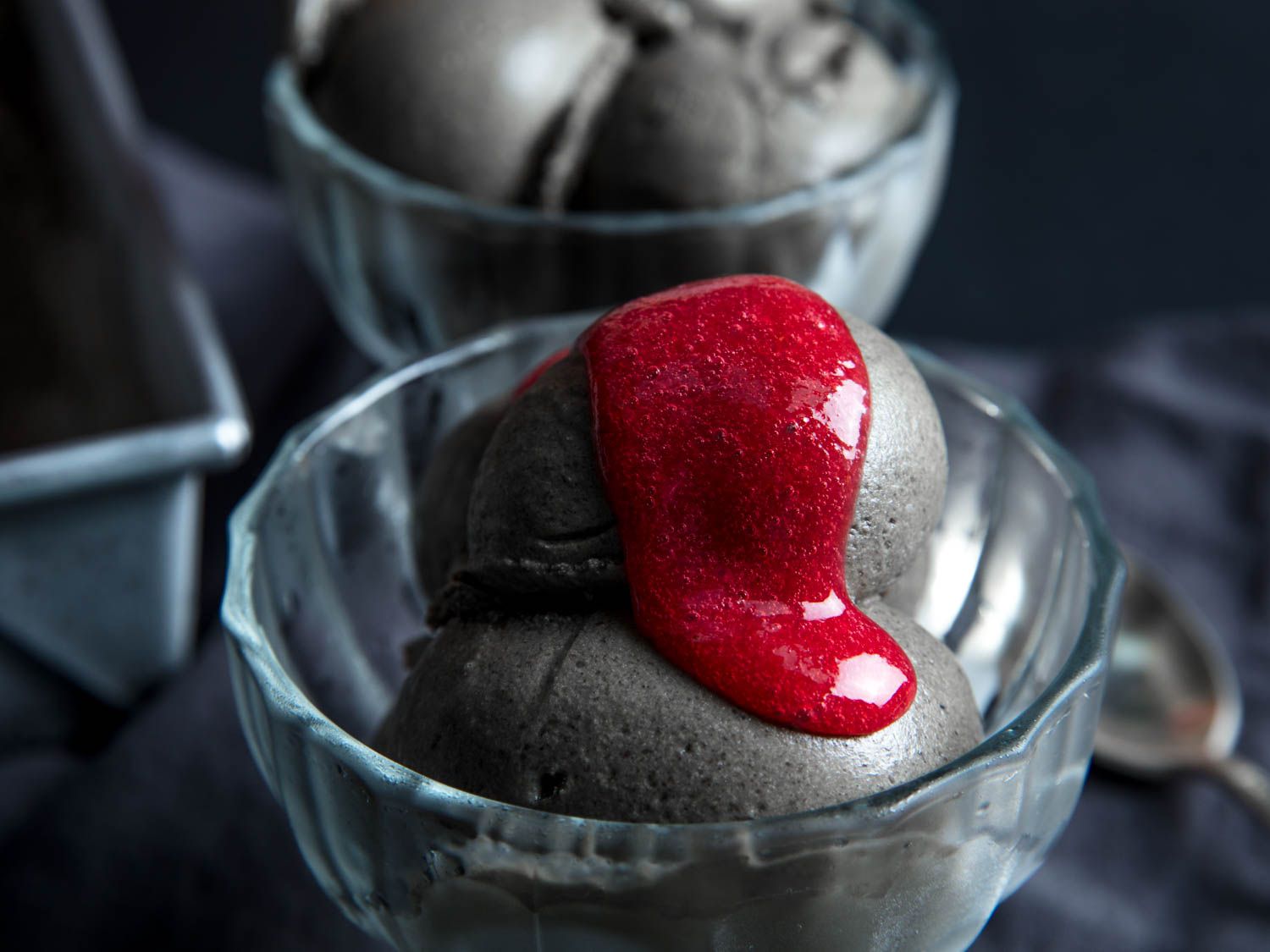 Black sesame ice cream topped with raspberry puree