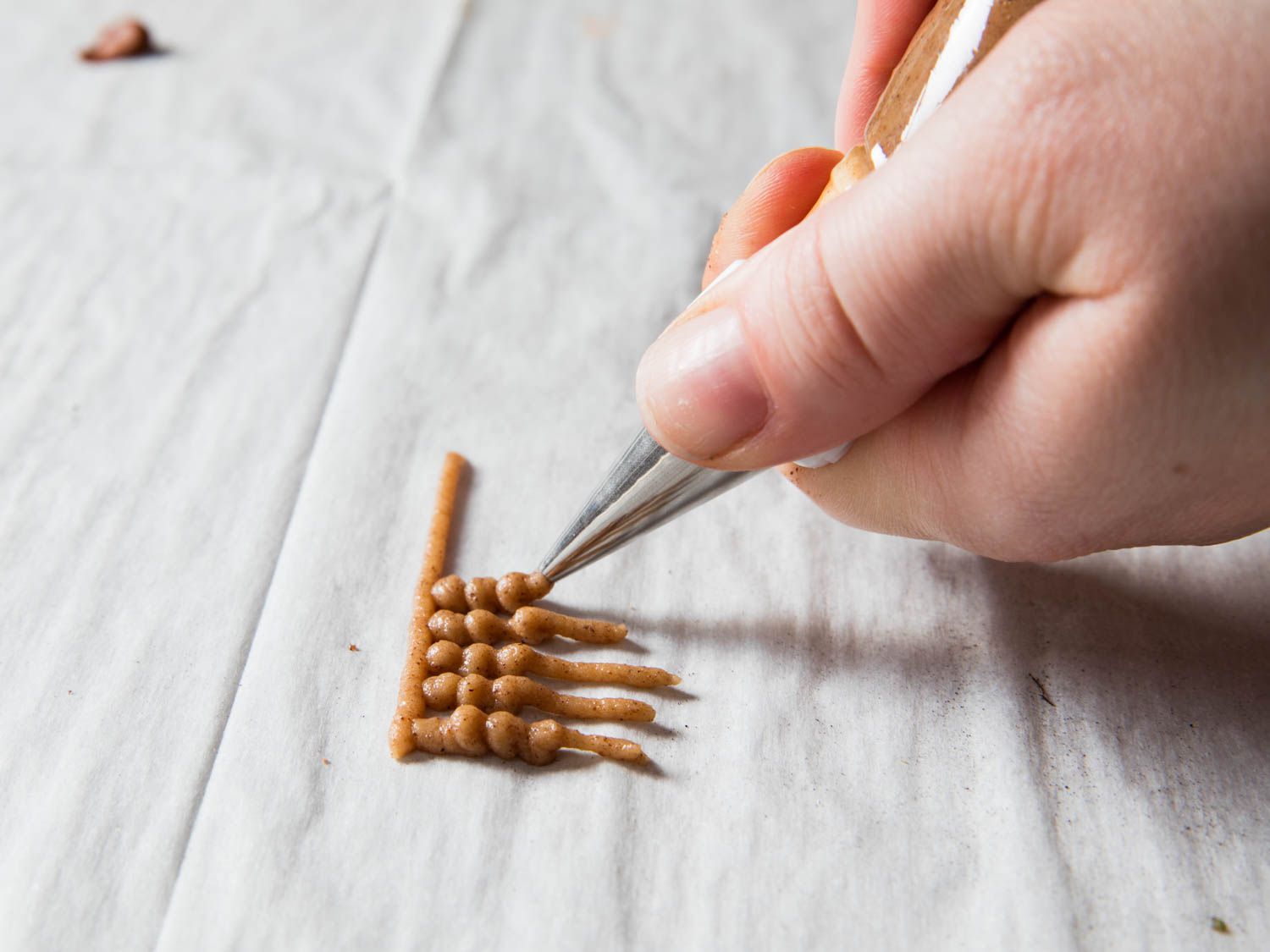 Piping out very fine details for the ginger bread house.