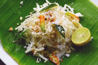 Quick Indian Cabbage Salad on a banana leaf with half a lime. 