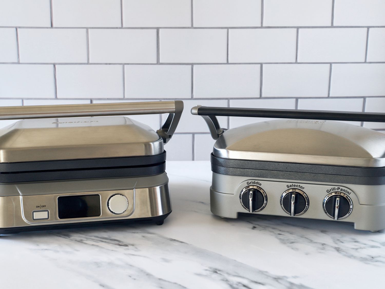 two panini presses on a marble surface