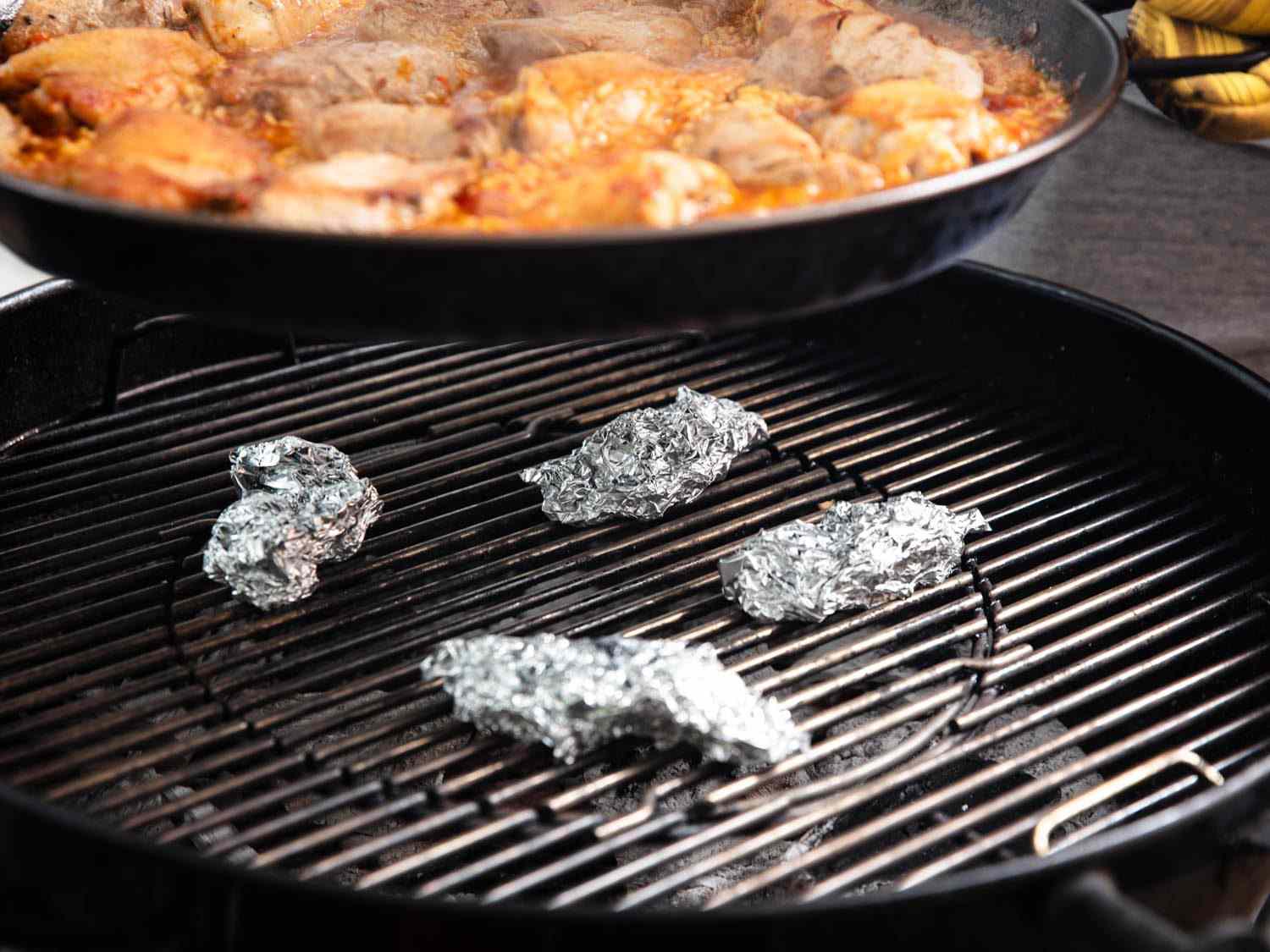 Pieces of aluminum foil can lift the paella pan a little farther from the heat when necessary.