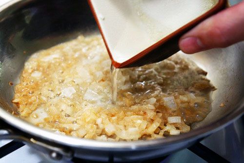 Adding onion juice to cooked, diced onion.
