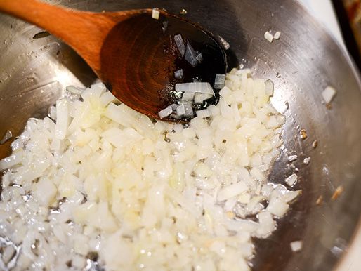 Chopped onions cooking in a pan.