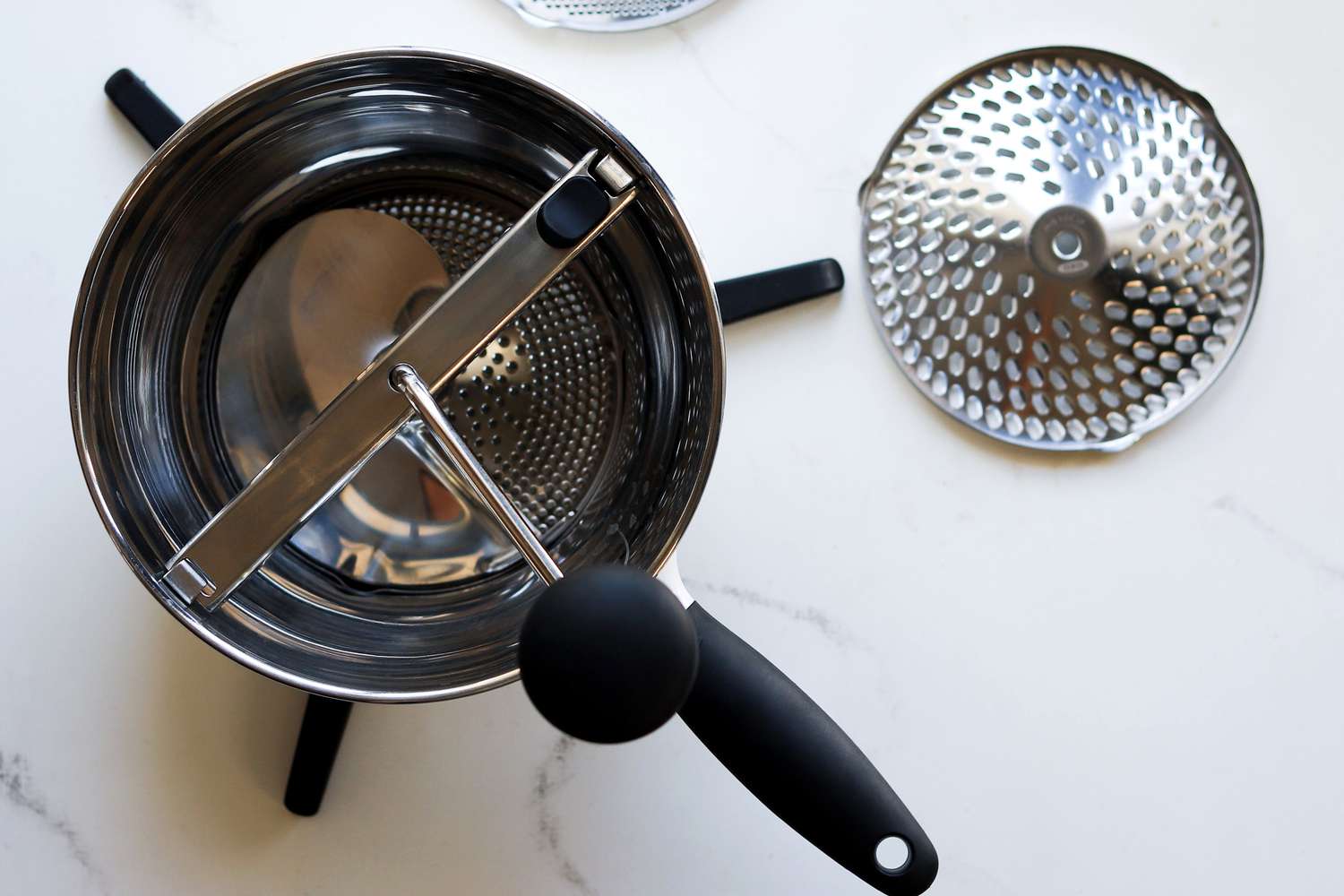 The oxo food mill on a marble surface