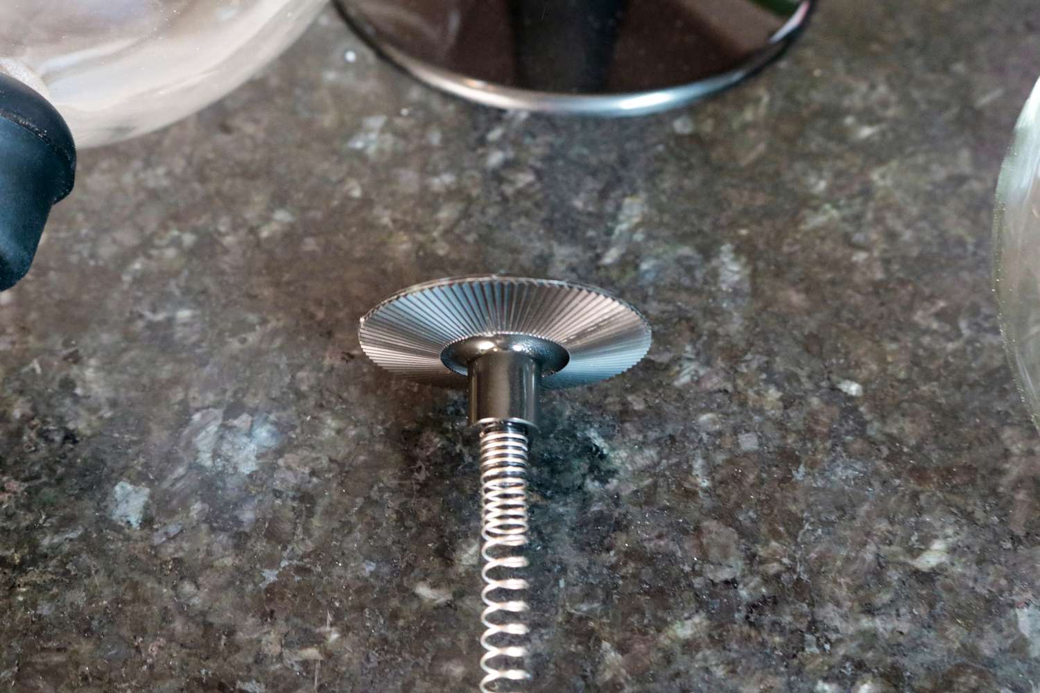 A closeup of a siphon coffee brewer's filter