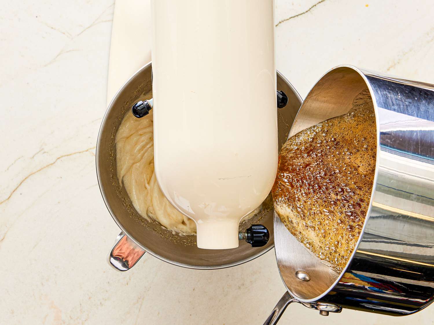 Overhead view of pouring sugar into egg white mixture