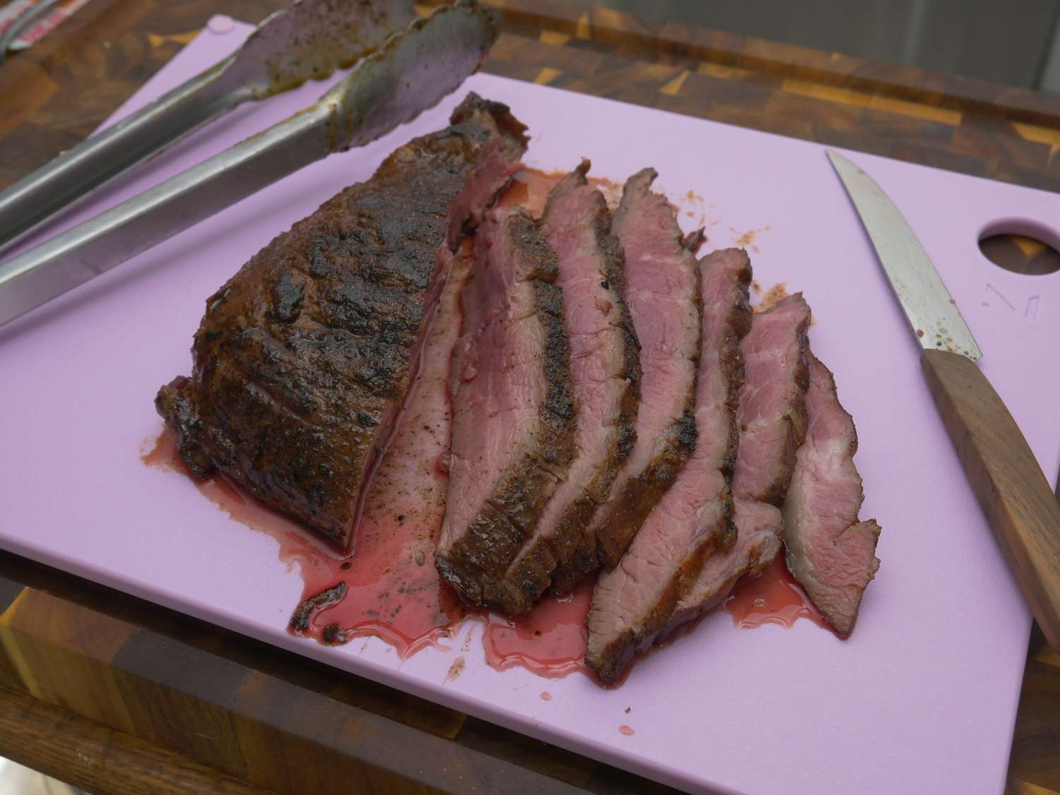 a piece of pork sliced on a purple cutting board