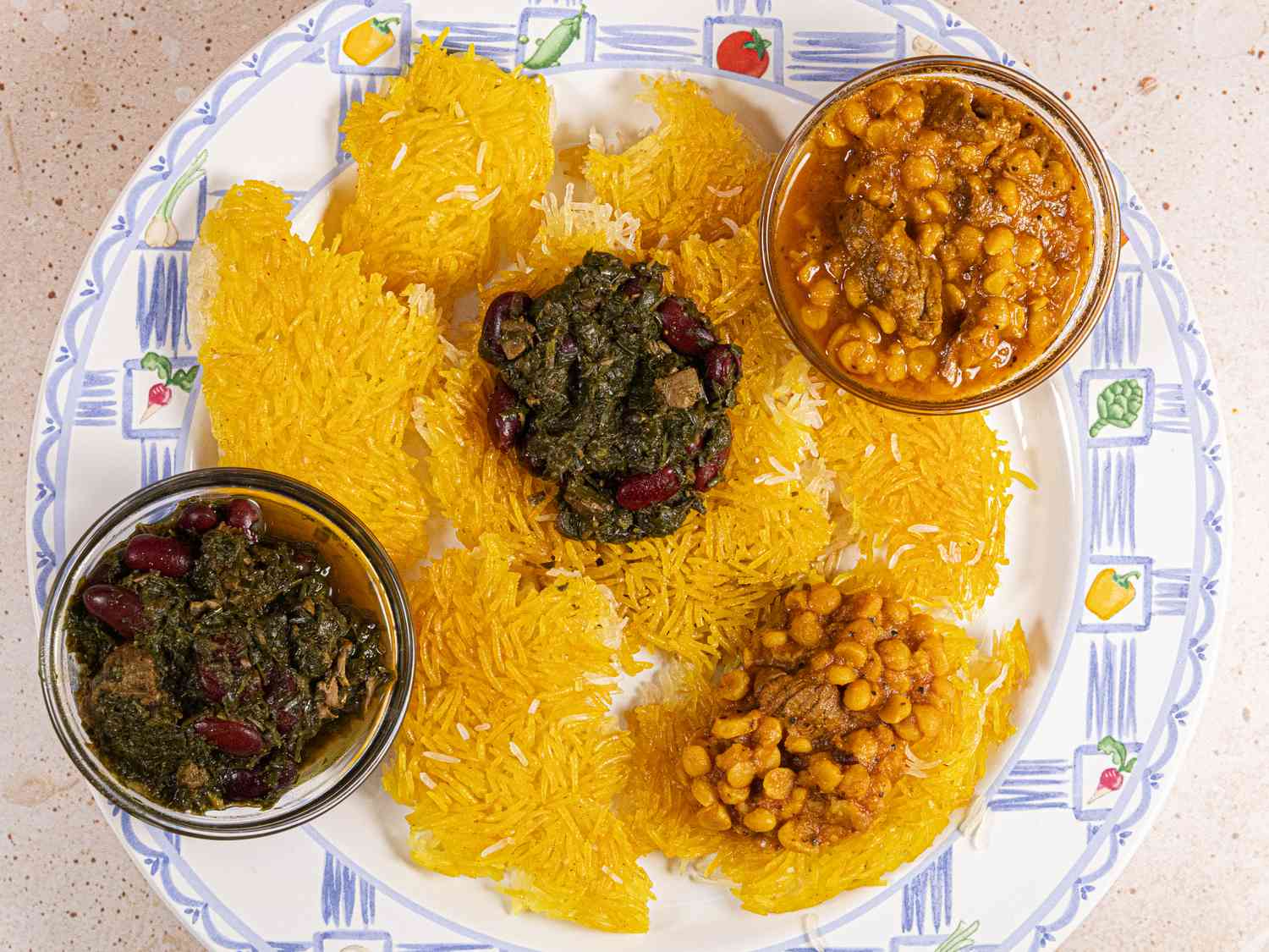 Overhead view of a plate of Tahdig with some sauces