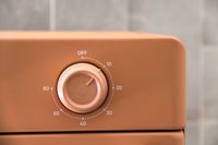 Close-up of a circular timer dial on an appliance, marked with time intervals from 10 to 60 and an 'off' position