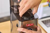A person adjusts the grind settings on the Lelit William Espresso Grinder
