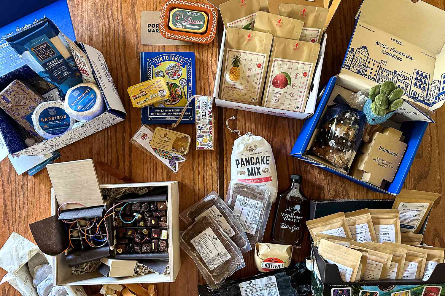 a variety of gift baskets contents on a wooden countertop