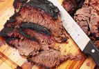 Sliced barbecued smoked beef chuck on a cutting board. 