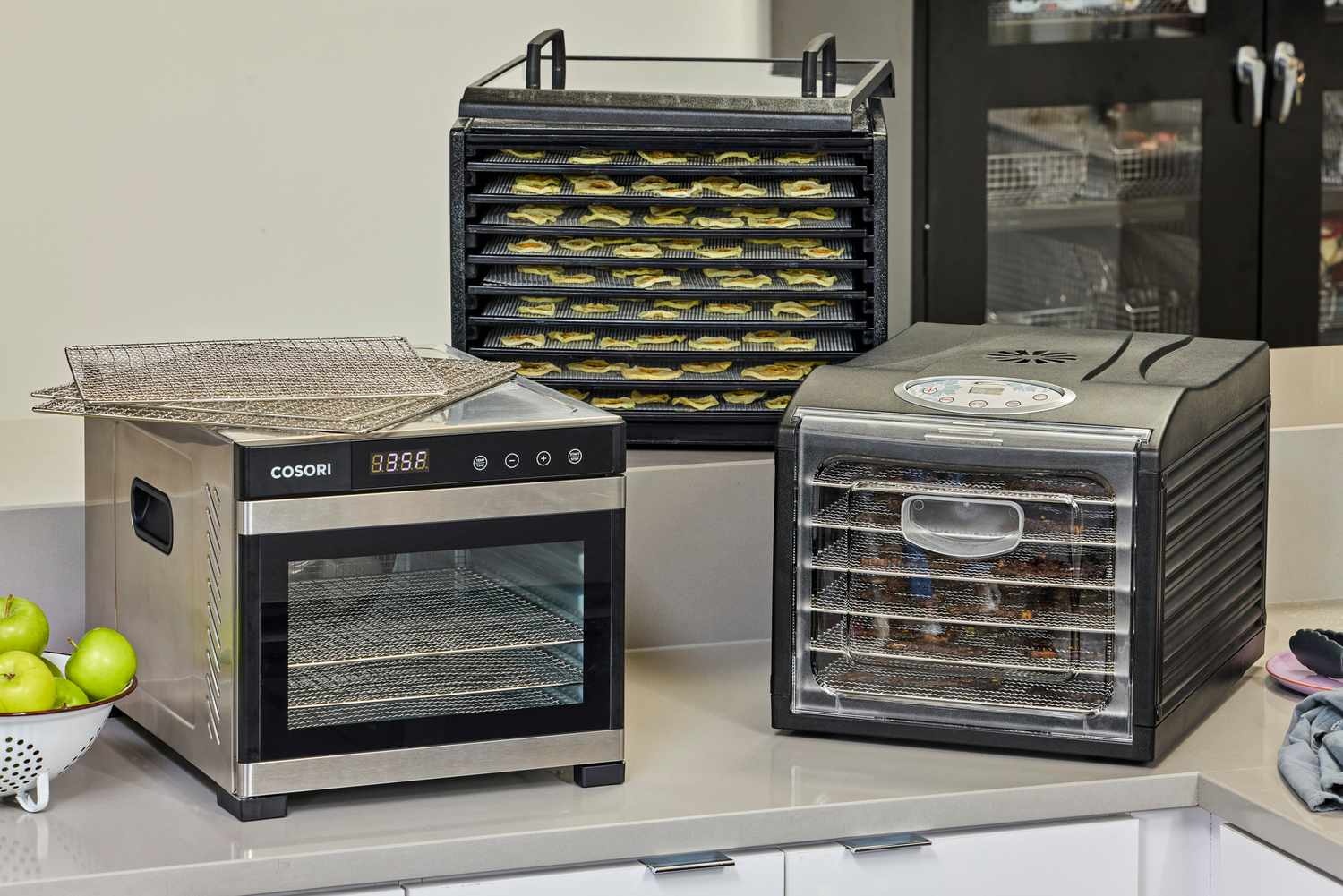 Three food dehydrators on a countertop