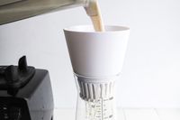 pouring blended nut and water mixture into the chefn strainer portion