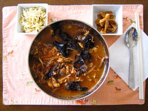 Overhead view of yukgaejang with accompaniments