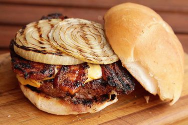 A barbecue bacon burger, topped with grilled onions.
