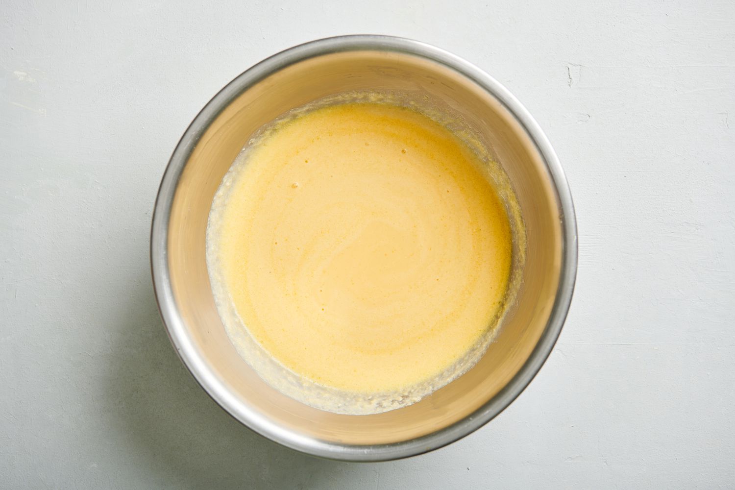 Smooth batter inside a medium mixing bowl.