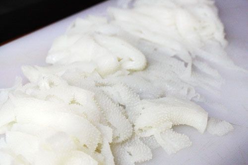 Omasum tripe, cleaned and cut into strips on a white cutting board.