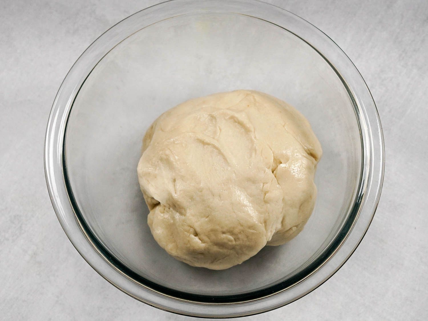 The tortilla dough is left to rest in a bowl.