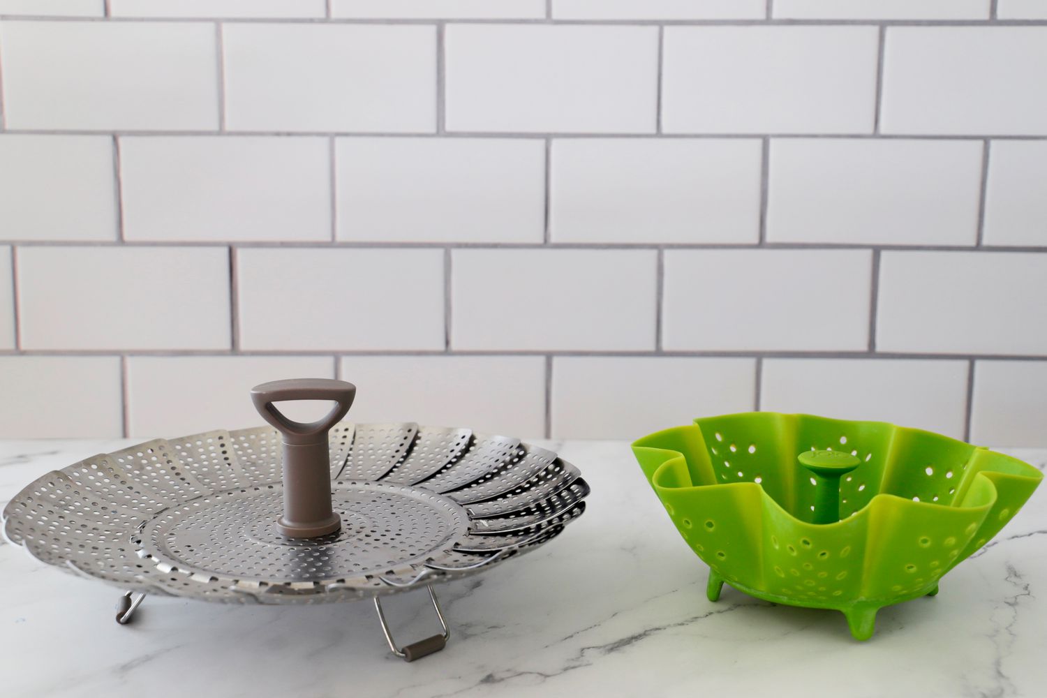 a stainless steel and silicone steamer basket side by side