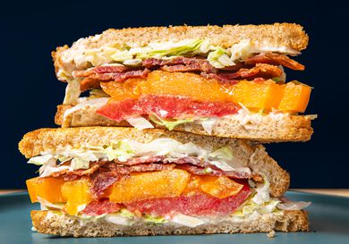 Two halves of a BLT stacked on top of each other