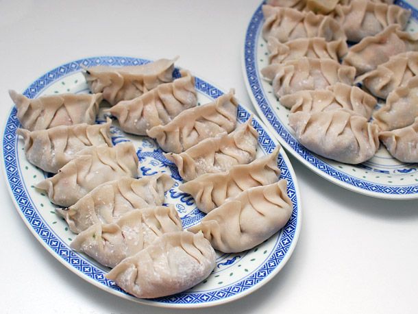 Formed vegetable dumplings lined up on 2 large plates.