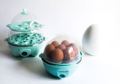 A collection of three egg cookers on a white background