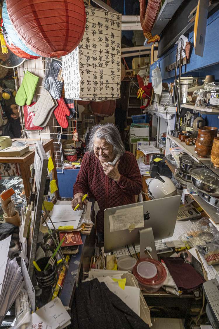 Tane Chan on the phone at the Wok Shop
