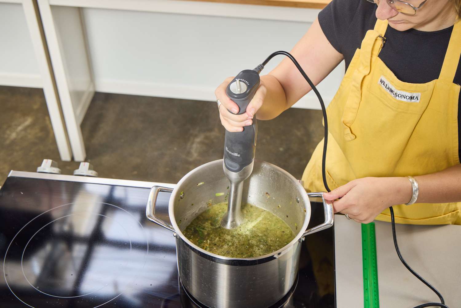 A person makes soup using the Breville Control Grip Immersion Blender