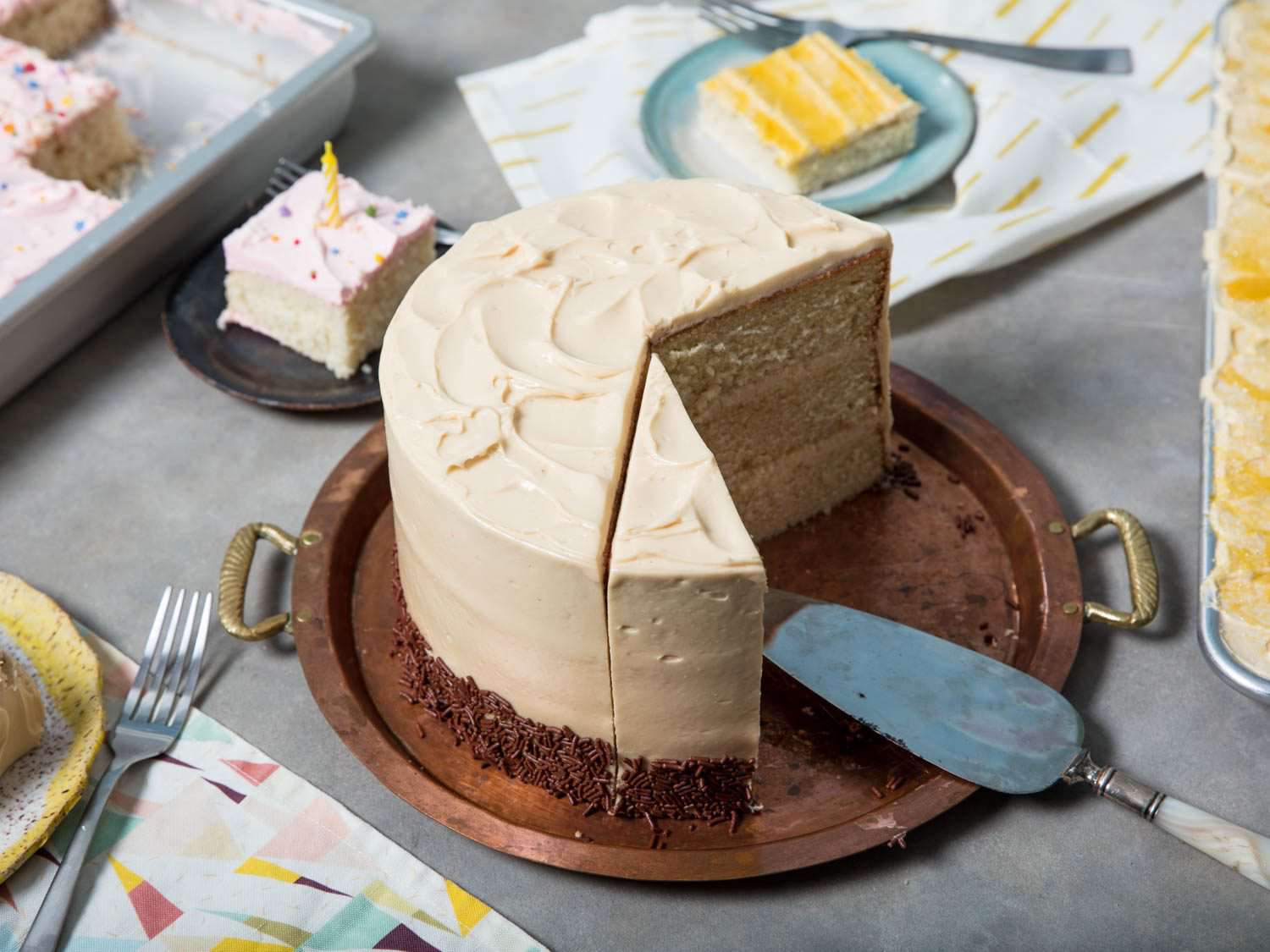 Serving slices from a round layer cake, sheet cake, and rectangular cake.