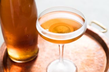 A three-piece suit cocktail served in a coupe glass.