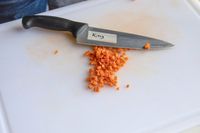 Diced carrots next to a knife 