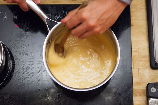 Stirring a pot of cheese sauce for fully-loaded nachos.