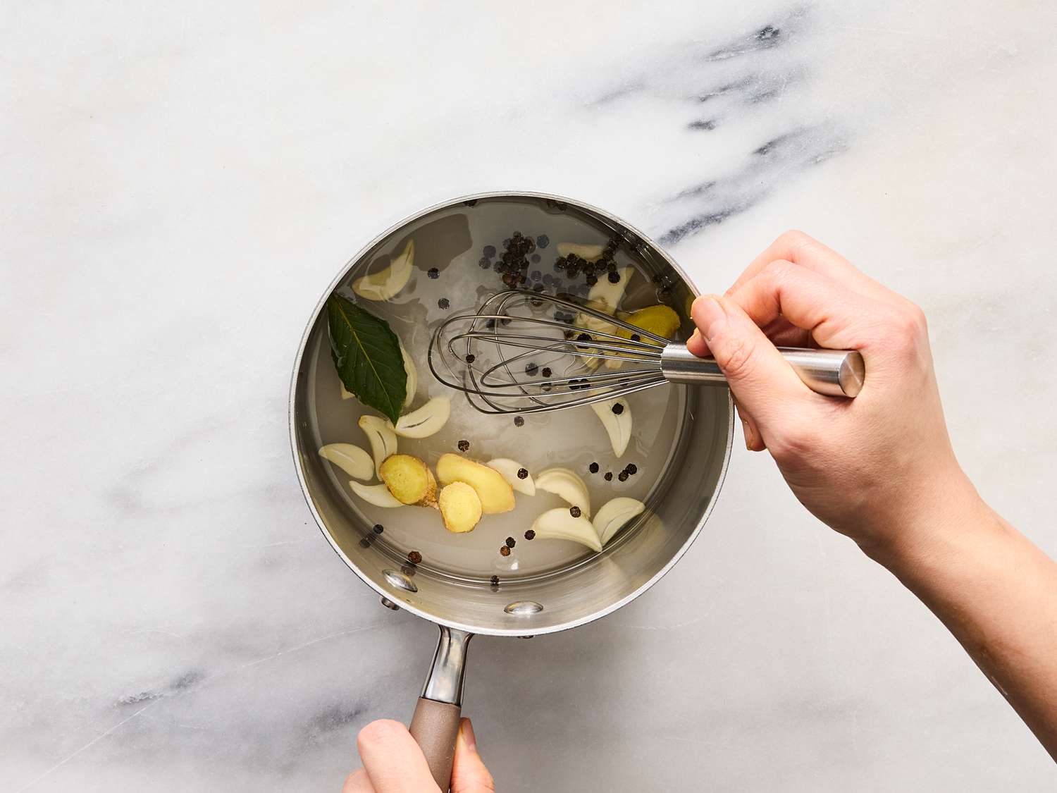 whisking vinegar mixture in saucepan 