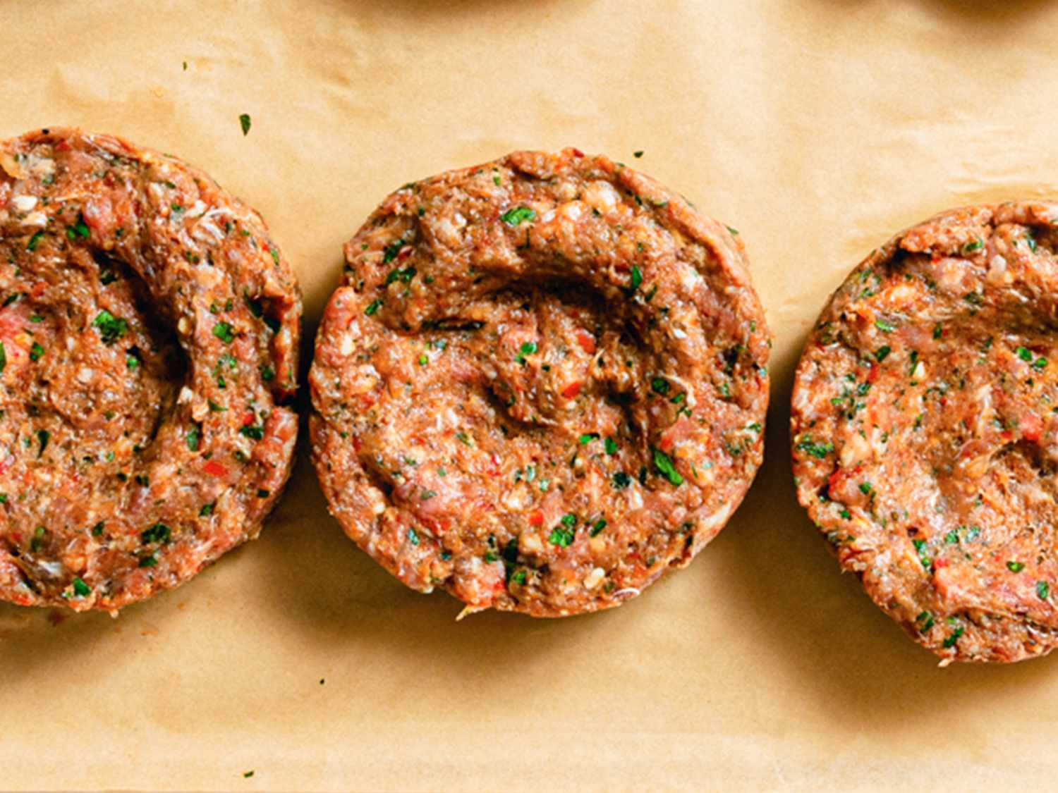 Dimpled ground meat mixture before grilling