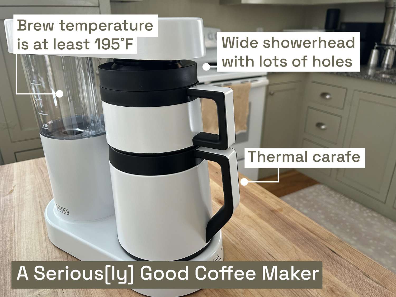 The Ratio Six coffee maker on a wooden table in a kitchen.