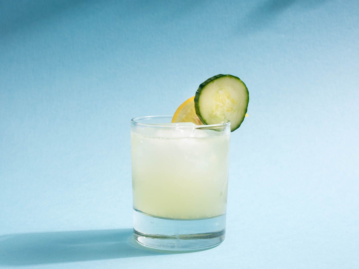 Pamplemousse cooler garnished with a cucumber wheel and lemon slice.