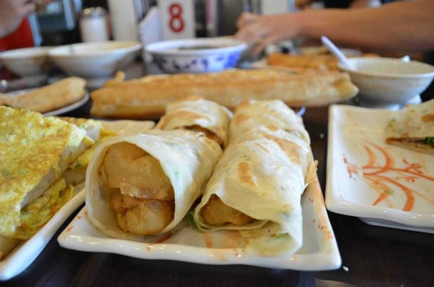 Thin green onion cakes rolled around twisted crullers.
