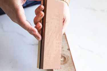 A person holding the King Whetstone sharpening set