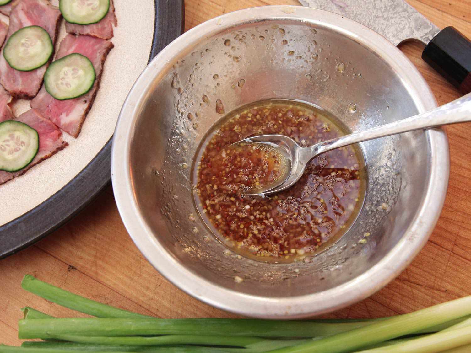 Closeup of a small mixing bowl of ponzu vinaigrette, ready to use.